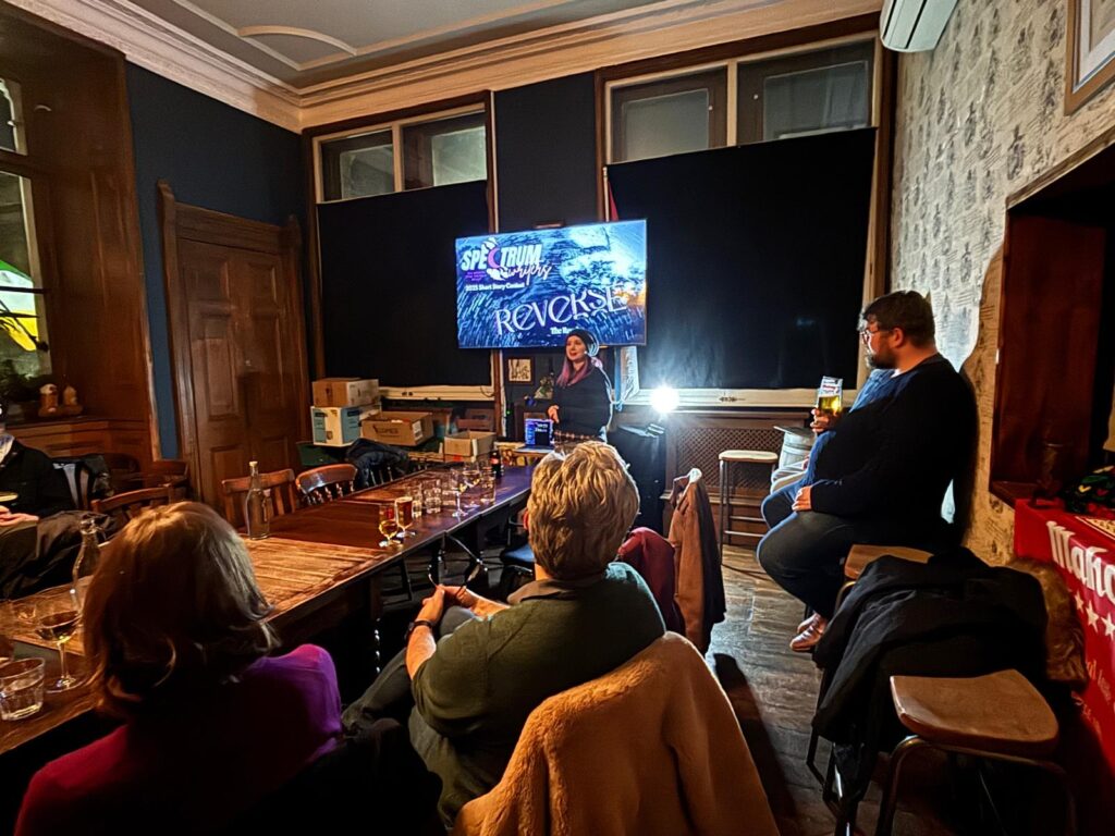 Organiser Kat Kourbeti presents the results of the 2025 short story contest.